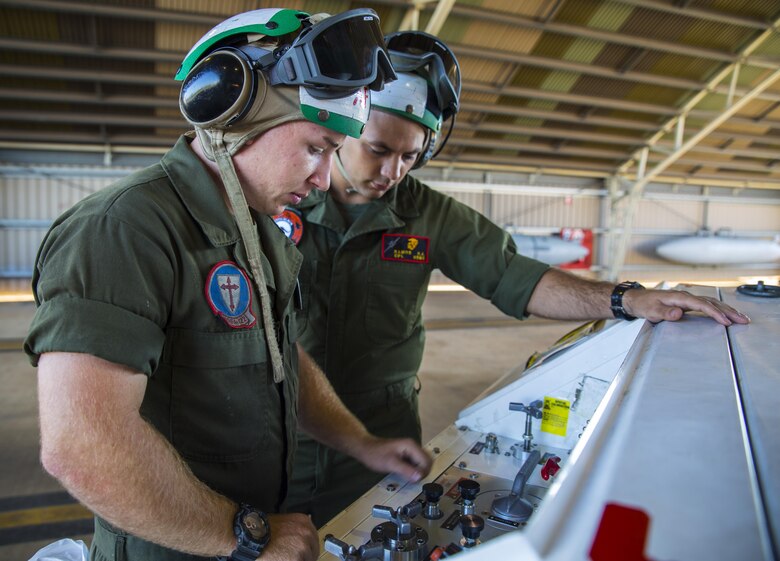 Lance Cpl. James Headrick, an airframe Marine with Marine Fighter Attack Squadron (VMFA) 122, demonstrates how to operate an NC-10 Hydraulic Generator for Cpl. Robert Ramos, Marine Aviation Logisitsics Squadron (MALS) 12 airframes, at Royal Australian Air Force Base Tindal, Australia, July 25, 2016. VMFA-122 traveled to RAAF Base Tindal for the first time to participate in Pitch Black 2016 and unit level training known as Southern Frontier. Pitch Black affords Marines with VMFA-122 the opportunity to integrate and increase interoperability with regional joint and coalition partners, while developing operational concepts for conducting sustained combat operations. Southern Frontier will help the squadron gain experience and qualifications in low altitude, air-ground, high explosive ordnance delivery at the unit level. (U.S. Marine Corps photo by Cpl. Nicole Zurbrugg) 