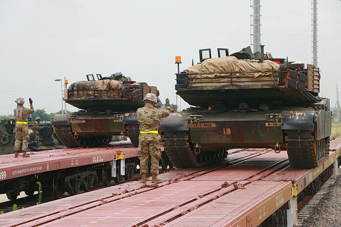Soldiers from the 2nd Battalion, 5th Cavalry Regiment, 1st Armored Brigade Combat Team, 1st Cavalry Division, guide the unloading of M1A2 Abrams main battle tanks from Korean railcars July 13 on US Army Garrison Humphreys. The effort to move 2nd Bn, 8th Cav. Reg., 1st ABCT, from Camp Stanley to USAG Humphreys required the assistance of Soldiers from four battalions, including the 1st Squadron, 7th Cavalry Regiment, 1st ABCT; the 91st Engineer Bn., 1st ABCT; and the 115th Brigade Support Bn., 1st ABCT.