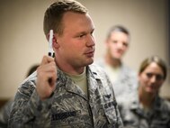 1st Lt Corey Leibbrand, a space officer, briefs the Space and Cyber cell on non-kinetic operations Friday, July 22, 2016, at Nellis Air Force Base, Nevada, during Red Flag 16-3. The exercise is aimed at teaching service members how to intergrate air, space and cyberspace elements. (U.S. Air Force photo/Tech. Sgt. David Salanitri) 