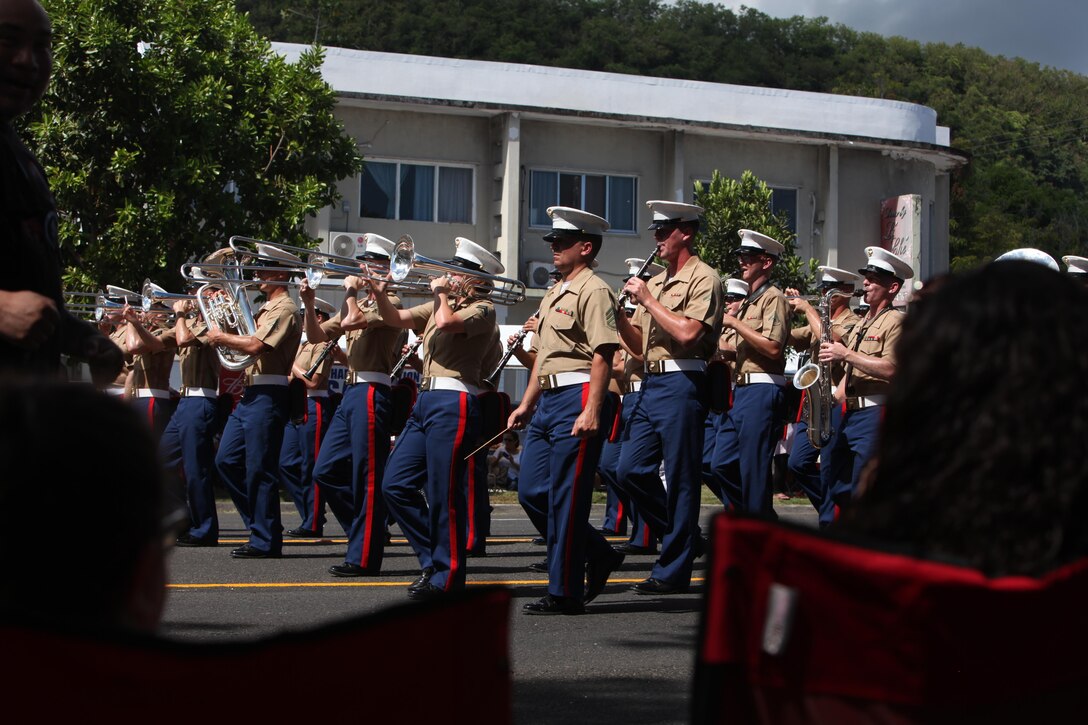 The III Marine Expeditionary Force Band marches in Guam behind the 3rd Marine Division color guard during Guam’s annual Liberation Day Parade July 21, 2016. This is the first time since Guam’s liberation that the color guard has been a part of the Liberation Day Parade. Today, presence of Marines and Sailors from 3rd Marine Division demonstrates the unwavering dedication of U.S. forces to partners and allies throughout the Indo-Asia-Pacific region.