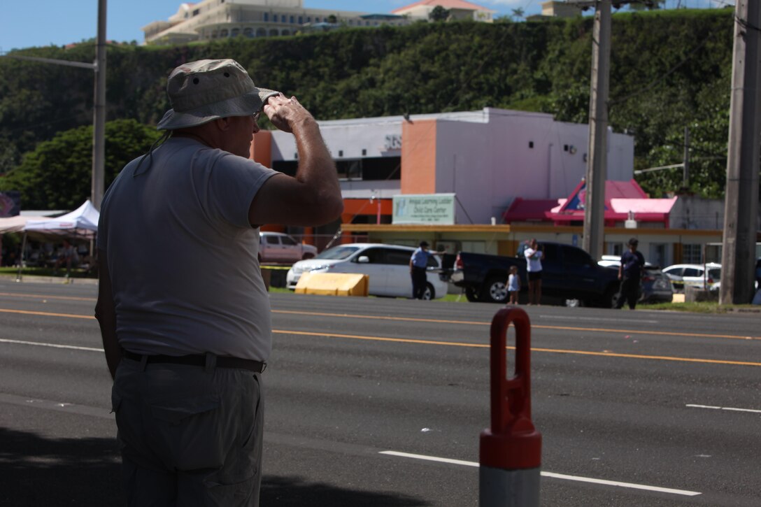 A parade atendee salutes the colors at Guam’s annual Liberation Day Parade July 21, 2016. This year’s parade was the first time since Guam’s liberation in 1944 that 3rd Marine Division’s color guard marched in the parade. Today, presence of Marines and Sailors from 3rd Marine Division demonstrates the unwavering dedication of U.S. forces to partners and allies throughout the Indo-Asia-Pacific region.