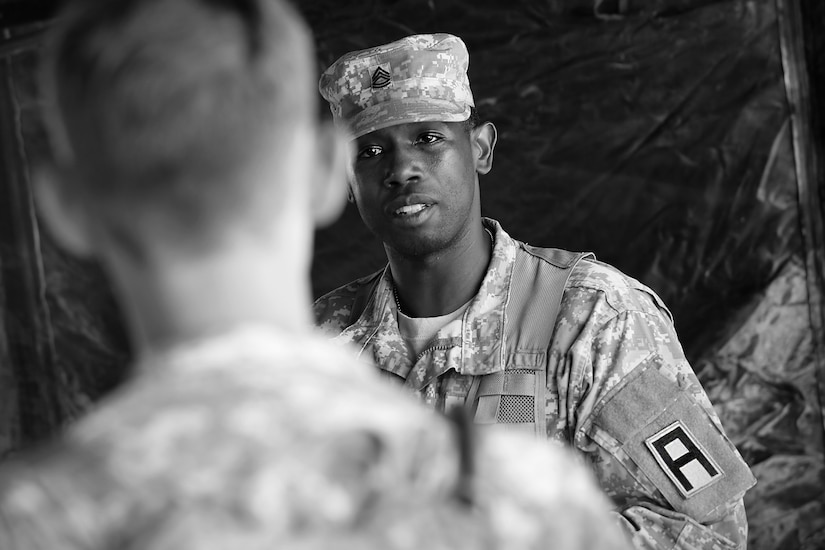 Sgt. 1st Class James McWilliams, observer-coach/trainer assigned to 1-409 Cavalry Battalion, 4th Cavalry Brigade, Fort Knox, speaks to a soldier assigned to the 371st Chemical Company, Greenwood, South Carolina, during a planning meeting at forward operating (training) base Justice, Fort McCoy, Wisconsin, July 11, 2016.
(U.S. Army photo by Mr. Anthony L. Taylor/Released)