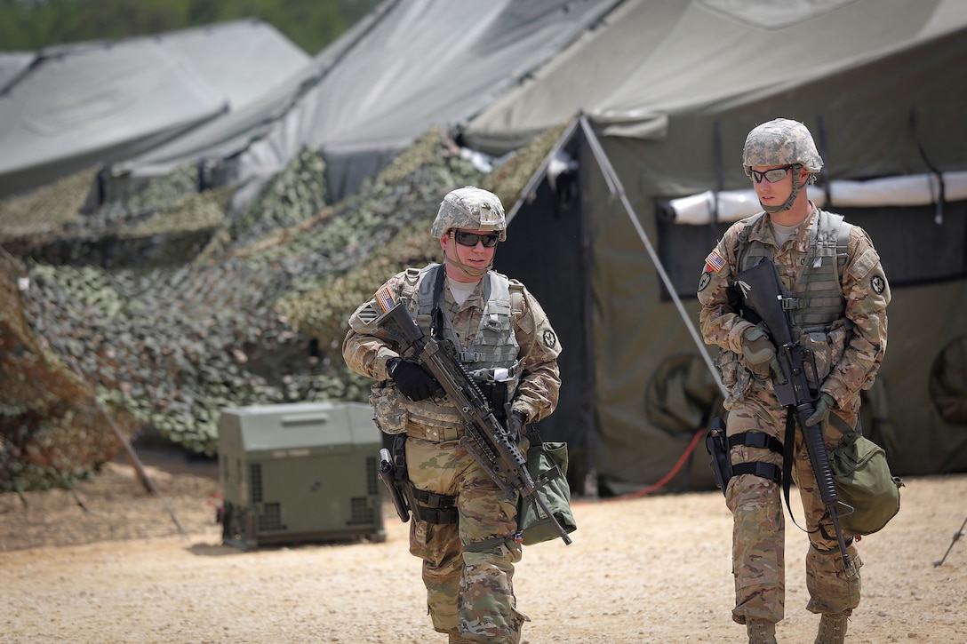 Military Police soldiers walk through tactical training base Patriot, Fort McCoy, Wisconsin, during Warrior Exercise 86-16-03, July 11, 2016. The soldiers assigned to TTB Patriot primarily train in convoy security, checkpoint procedures, and escort missions.
(U.S. Army photo by Mr. Anthony L. Taylor/Released)
