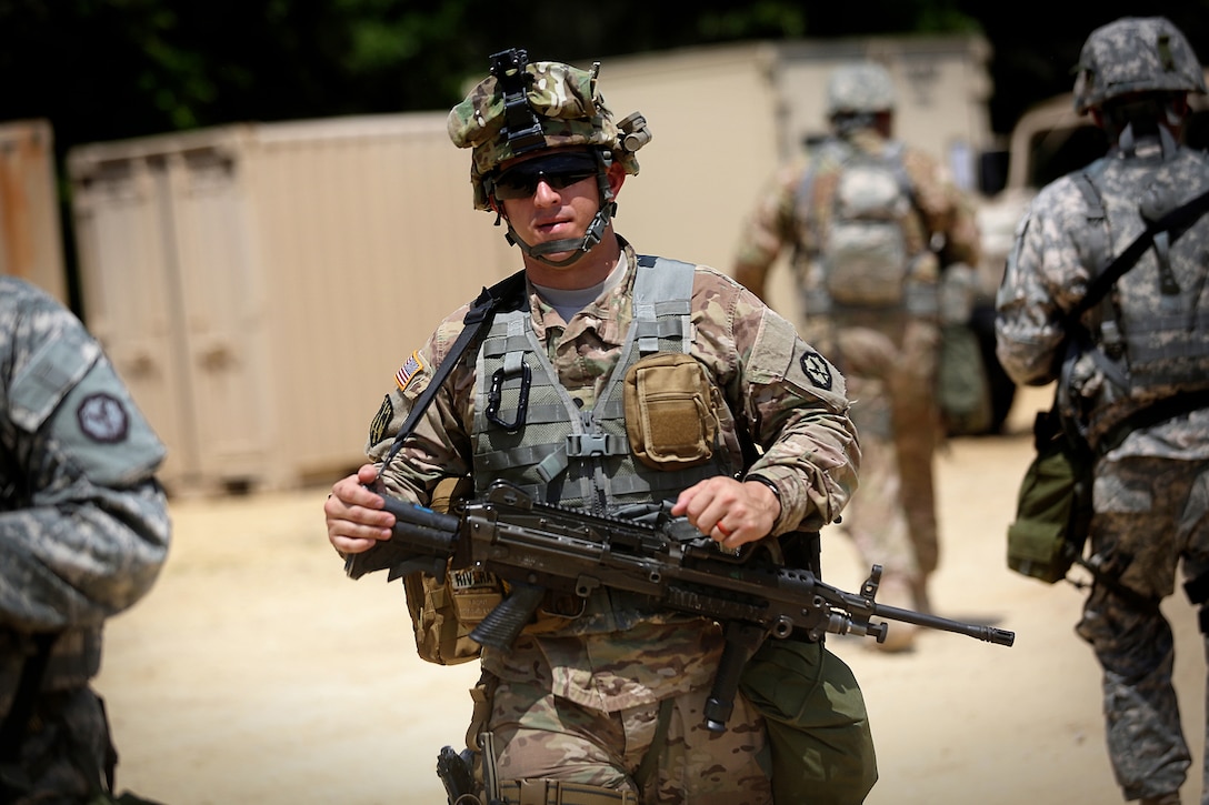 A soldier assigned to the 320th Military Police Company, Saint Petersburg, Florida, walks through tactical training base Patriot, Fort McCoy, Wisconsin, during Warrior Exercise 86-16-03, July 11, 2016. The soldiers assigned to TTB Patriot primarily train in convoy security, checkpoint procedures, and escort missions.
(U.S. Army photo by Mr. Anthony L. Taylor/Released)