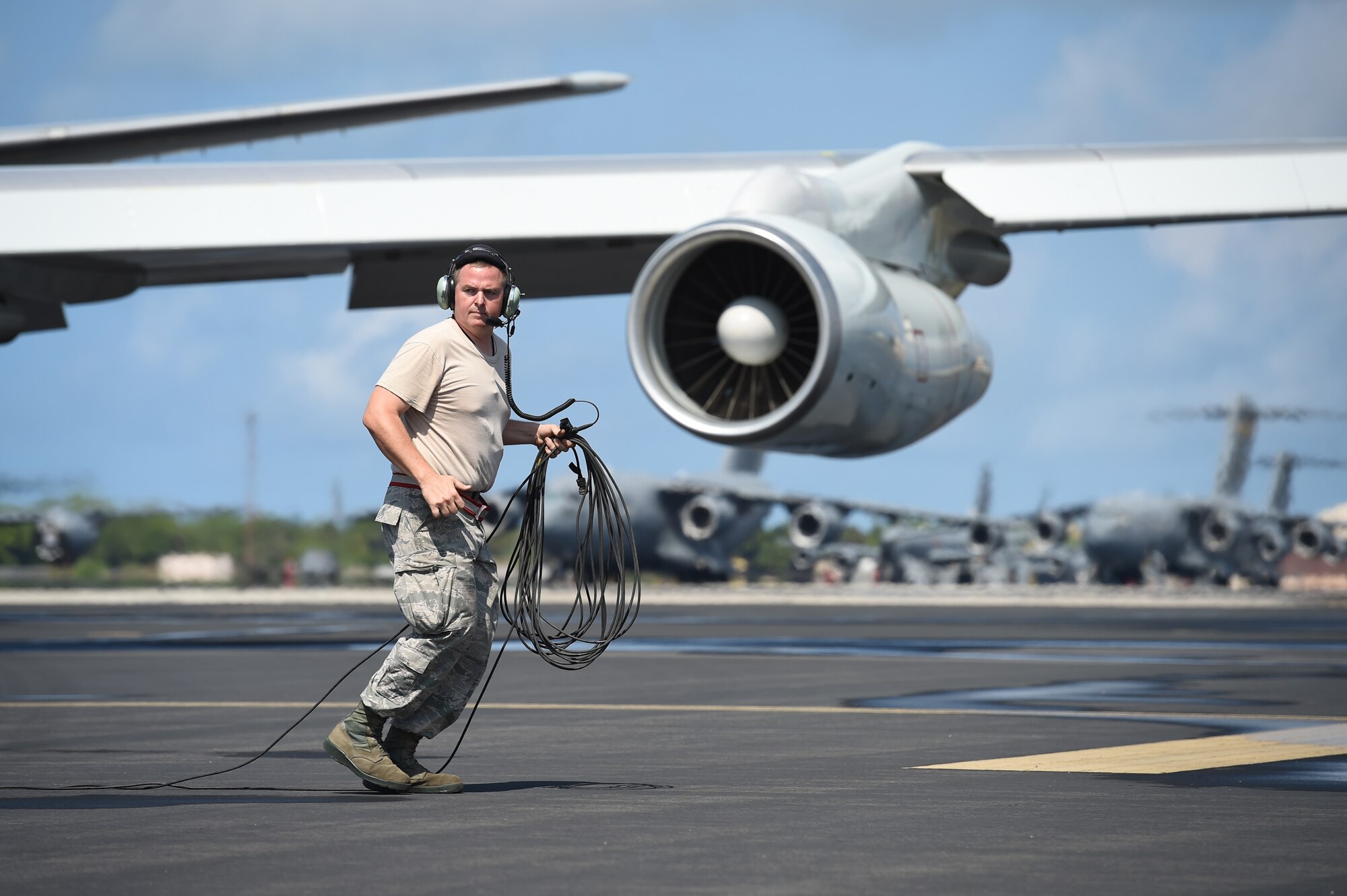 Tech. Sgt. Robert Adams, a crew chief assigned to the 513th Aircraft Maintenance Squadron, moves to safety July 19, 2016, at Joint Base Pearl Harbor-Hickam, Hawaii, as an E-3 Sentry flown by Reservists from the 513th Air Control Group prepares to taxi before a mission in support of Rim of the Pacific 2016. More than 125 Airmen from the 513th Air Control Group and 552nd Air Control Wing are deployed to Hawaii in support of the RIMPAC 2016 exercise. Twenty-six nations, more than 40 ships and submarines, more than 200 aircraft and 25,000 personnel are participating in RIMPAC from June 30 to Aug. 4, in and around the Hawaiian Islands and Southern California. The world's largest international maritime exercise, RIMPAC provides a unique training opportunity that helps participants foster and sustain the cooperative relationships that are critical to ensuring the safety of sea lanes and security on the world's oceans. RIMPAC 2016 is the 25th exercise in the series that began in 1971. (U.S. Air Force photo by 2nd Lt. Caleb Wanzer)