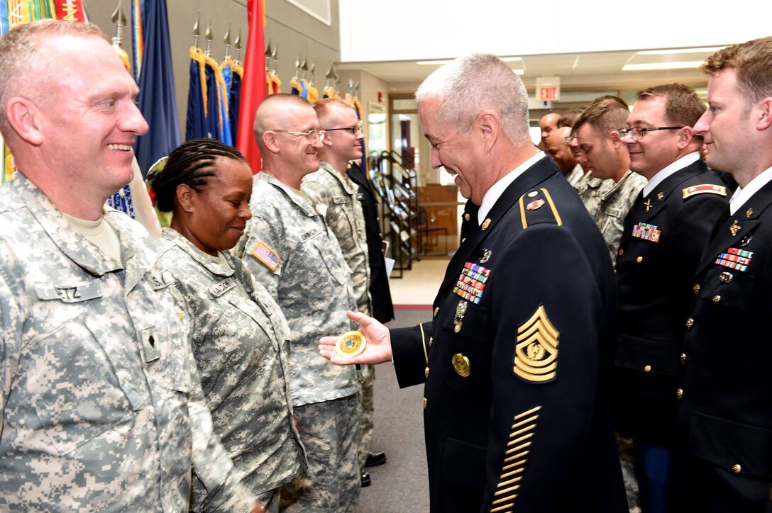 Command Sgt. Maj. Kevin Greene, 85th Support Command, Command Sergeant Major, presents command coins to the newly formed color guard at the command headquarters on July 9, 2016. The color guard was formed just a few hours before representing the 85th Support Command at the 2nd Mobilization Support Group's Change of Command ceremony.
(Photo by Sgt. Aaron Berogan