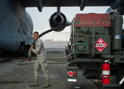 Airman Seth Roy, 628th Logistic Readiness Squadron fuels distribution operator, smiles while holding a fuel hose July 18, 2016, at Joint Base Charleston, S.C. Last year, over 50 Airmen of the 628th LRS fuels flight provided the base with more than 36 million gallons of fuel for missions throughout the base. (U.S. Air Force photo/Staff Sgt. Jared Trimarchi)


