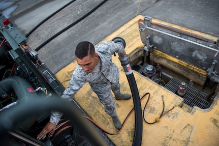 Airman Seth Roy, 628th Logistic Readiness Squadron fuels distribution operator, puts away a fuel hose July 18, 2016, at Joint Base Charleston, S.C. Last year, over 50 Airmen of the 628th LRS fuels flight provided the base with more than 36 million gallons of fuel for missions throughout the base. (U.S. Air Force photo/Staff Sgt. Jared Trimarchi)
