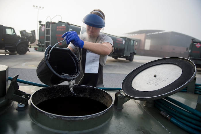 An Airman from the 628th Logistic Readiness Squadron fuels flight pours fuel July 18, 2016 at Joint Base Charleston, S.C. Last year, over 50 Airmen of the 628th LRS fuels flight provided the base with more than 36 million gallons of fuel for missions throughout the base. (U.S. Air Force photo/Staff Sgt. Jared Trimarchi)

