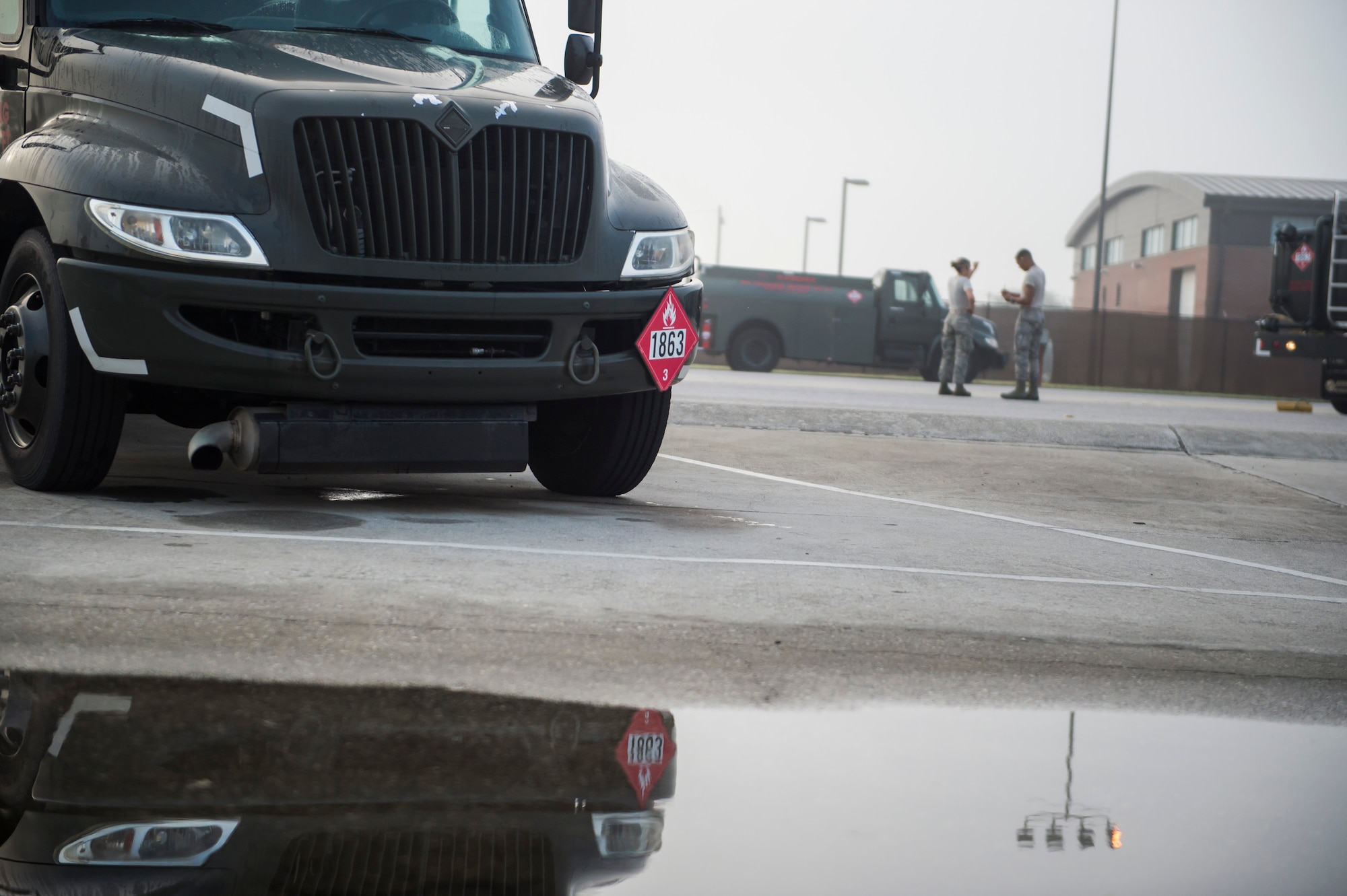 628th Logistic Readiness Squadron fuel distribution operators discuss the morning fuel vehicle inspections July 18, 2016 at Joint Base Charleston, S.C. Last year, over 50 Airmen of the 628th LRS fuels flight provided the base with more than 36 million gallons of fuel for missions throughout the base. (U.S. Air Force photo/Staff Sgt. Jared Trimarchi)
 
