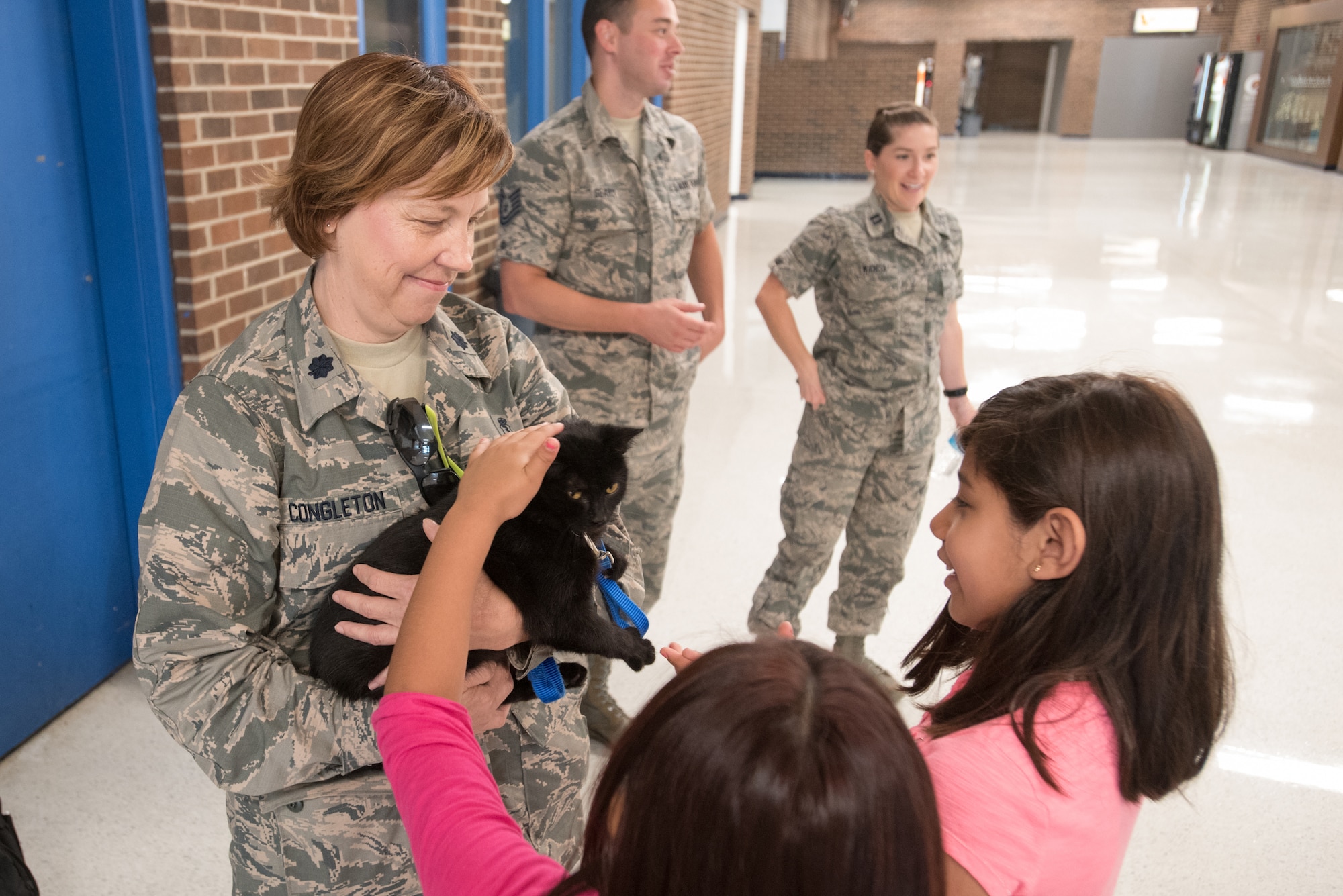 Lt. Col. Carolyn Congleton (left), chief of public health from the Kentucky Air National Guard’s 123rd Medical Group, holds a kitten from the Mayfield-Graves County Animal Shelter at Graves County High School in Mayfield, Ky., on July 26, 2016, during Bluegrass Medical Innovative Readiness Training. Congleton conducted a free pet safety seminar to residents of Western Kentucky as part of the IRT.  The Kentucky Air National Guard, U.S. Navy Reserve and other military units are teaming with the Delta Regional Authority to offer medical and dental care at no cost to residents in Mayfield and two other Western Kentucky locations from July 18 to 27 as part of the training event. (U.S. Air National Guard photo by Master Sgt. Phil Speck)