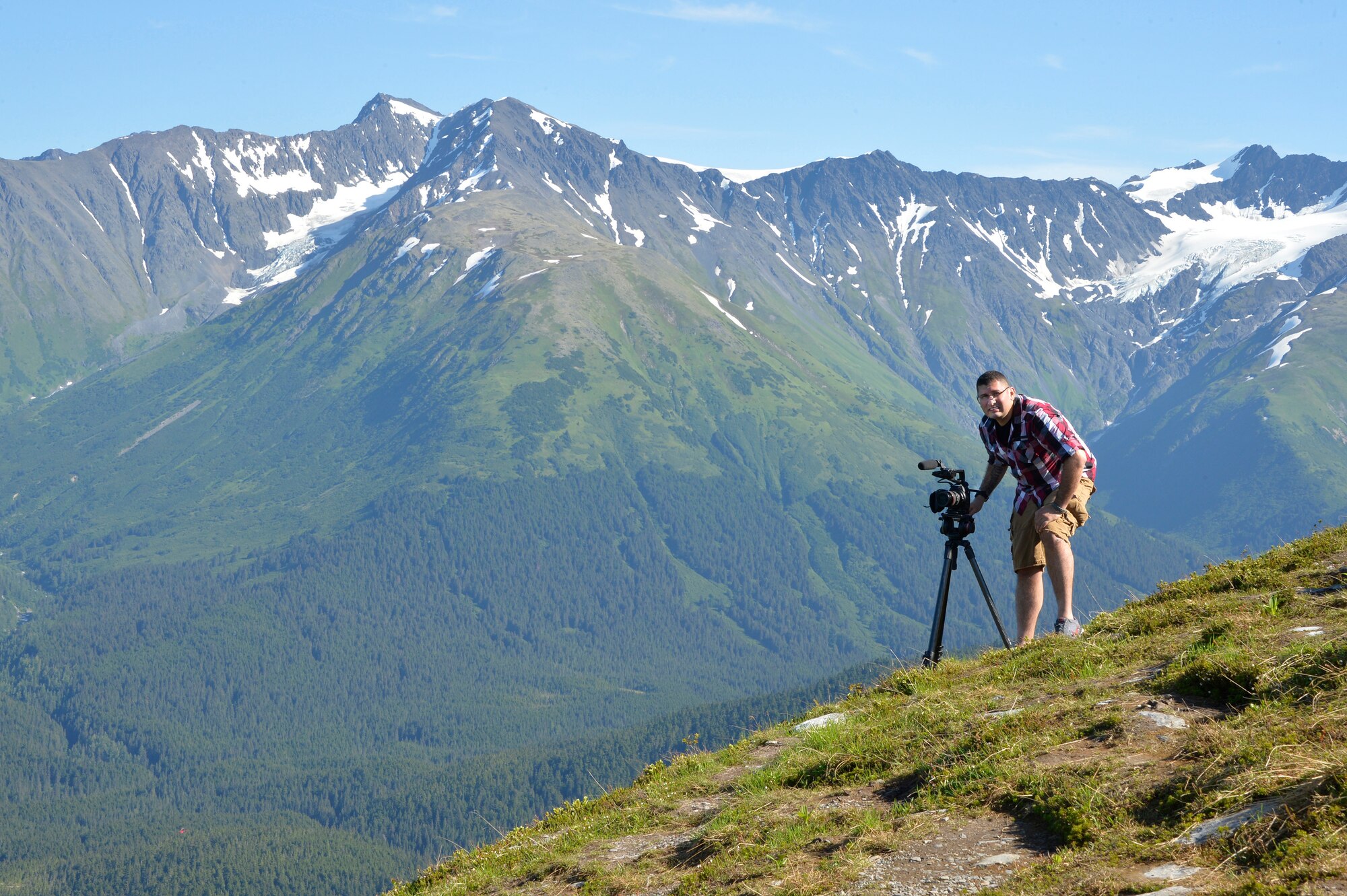 Tech. Sgt. Erik Gallion, a public affairs broadcaster assigned to the I.G. Brown Training and Education Center, pauses while filming lanscapes, July 12, 2016, in Alyeska Alaska. (U.S. Air National Guard photo by Master Sgt. Jerry D. Harlan)