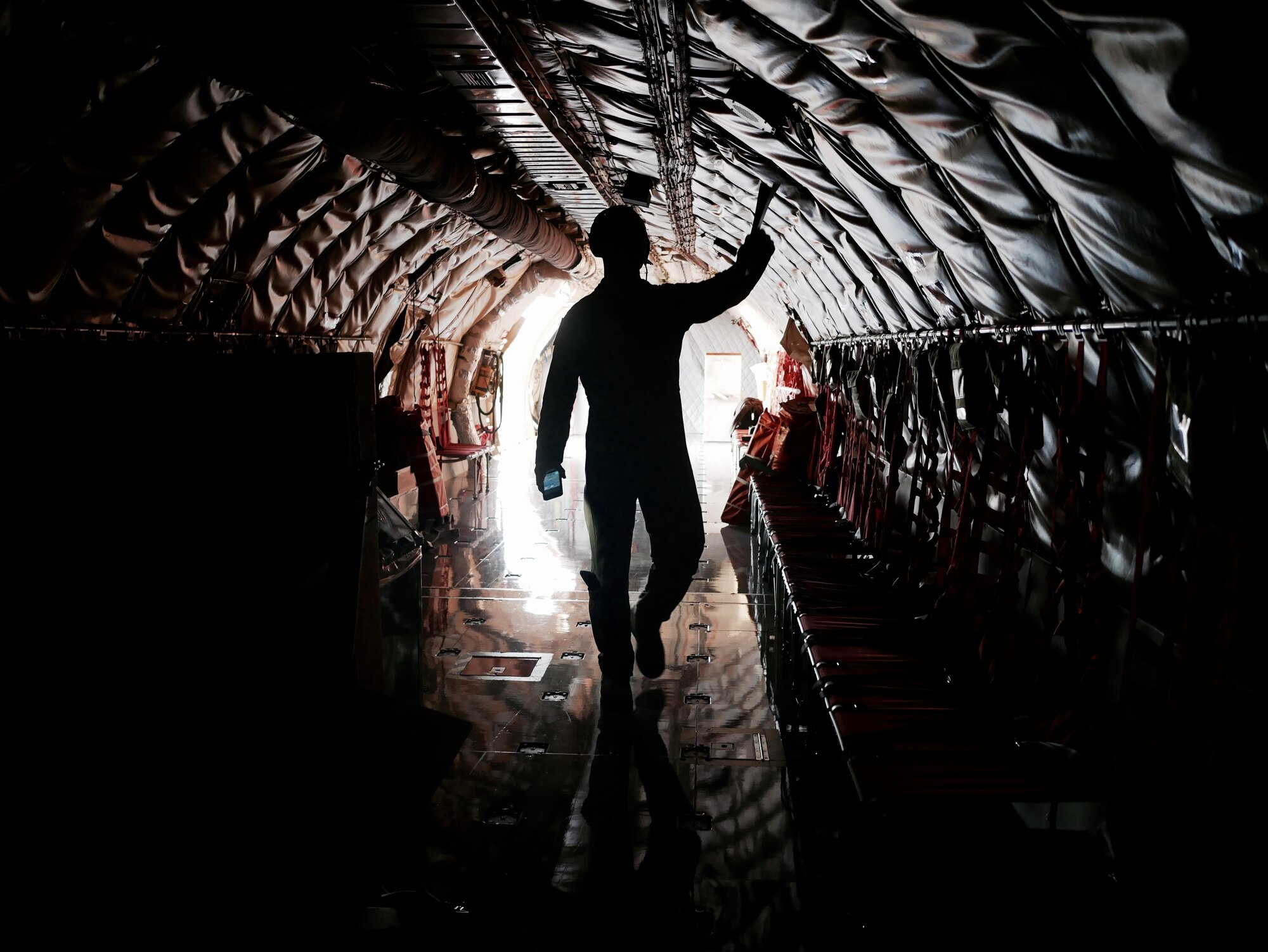 A U.S. Air Force boom operator for the 909th Air Refueling Squadron inspects the fuselage of a KC-135R Stratotanker June 21, 2016, at Kadena Air Base Japan. While pilots are responsible for flying the aircraft and handling the majority of operations in the cockpit, boom operators look after the rest of the aircraft while in flight. (U.S Air Force photo by Senior Airman John Linzmeier)
