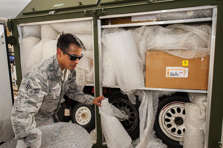 U.S. Air Force Senior Airman Victor Covarrubias-Ruiz, 18th Logistics Readiness Squadron cargo deployment function journeyman, inspects a cargo container July 20, 2016, at Kadena Air Base, Japan. A majority of the cargo the cargo deployment function handles is related to launching jets from a downrange location, though they also handle off-road vehicles, watercraft and humanitarian relief aid. (U.S. Air Force photo by Airman 1st Class Corey M. Pettis)