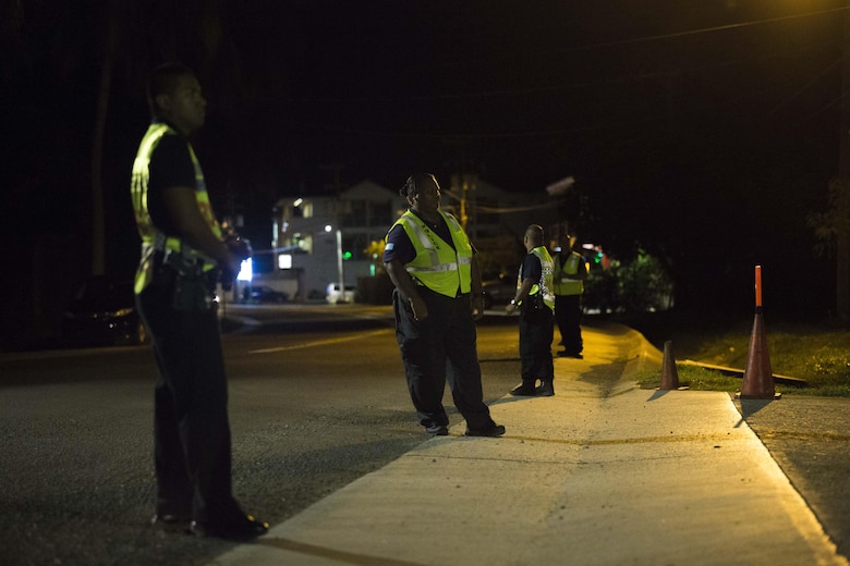 Police officers with the Palaun Police set up security and block roads for U.S. Marines with the Maritime Raid Force, 31st Marine Expeditionary Unit while they conduct training at Koror, Palau on July 22, 2016. The Marines are conducting training in Palau to ensure familiarity with Palau's complex urban environment. The training events were planned out with local authorities to provide an opportunity for realistic training with minimal inconvenience to the community and environment. (U.S. Marine Corps photo by Lance Cpl. Jorge A. Rosales/ Released)