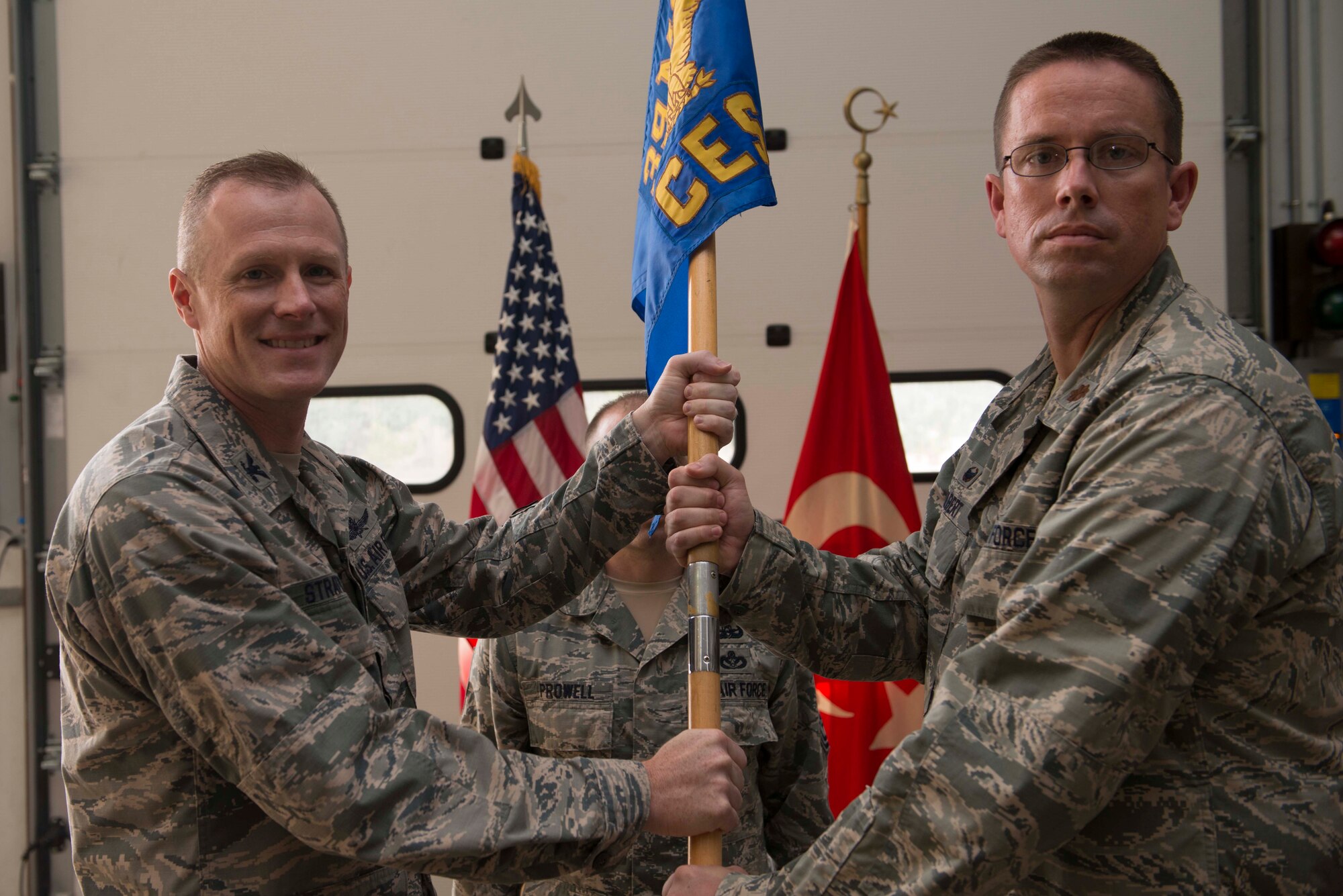 U.S. Air Force Maj. Myles Gilbert, 39th Civil Engineer Squadron (CES) incoming commander, receives command from Col. Todd Stratton, 39th Mission Support Group commander, during a change of command ceremony July 18, 2016, at Incirlik Air Base, Turkey. Prior to taking command, Gilbert served as the 49th CES operations flight commander at Holloman Air Force Base, N.M. (U.S. Air Force photo by Senior Airman John Nieves Camacho)