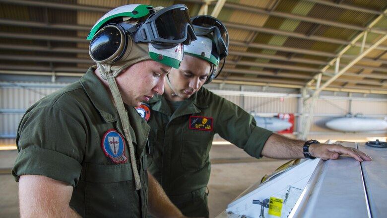 Lance Cpl. James Headrick, an airframe Marine with Marine Fighter Attack Squadron 122, demonstrates how to operate an NC-10 Hydraulic Generator for Cpl. Robert Ramos, Marine Aviation Logisitsics Squadron 12 airframes, at Royal Australian Air Force Base Tindal, Australia, July 25, 2016. VMFA-122 traveled to RAAF Base Tindal for the first time to participate in Pitch Black 2016 and unit level training known as Southern Frontier. Pitch Black affords Marines with VMFA-122 the opportunity to integrate and increase interoperability with regional joint and coalition partners, while developing operational concepts for conducting sustained combat operations. Southern Frontier will help the squadron gain experience and qualifications in low altitude, air-ground, high explosive ordnance delivery at the unit level.