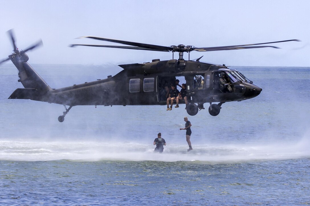 Army Rangers jump from a UH-60M Black Hawk helicopter during a water insertion off the coast of Tybee Island, Ga., July 20, 2016. Army photo by Spc. Scott Lindblom