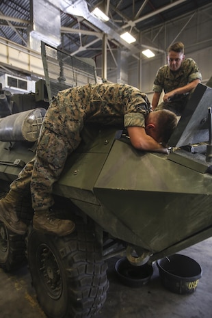 Two Marines with 2nd Maintenance Battalion work on a light armored vehicle as part of their daily work at Camp Lejeune, N.C., July 21, 2016. 2nd Maint. Bn. recently received the Chesty Puller Award, the Ground Safety Award and the Department of Defense Maintenance Award for the Marines excelling at their jobs individually and collectively. (U.S. Marine Corps photo by Lance Cpl. Miranda Faughn/Released)
