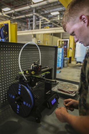 Lance Cpl. Christopher Bigham, a metal worker with 2nd Maintenance Battalion works with a 3-D printer to discover new ways it can help the battalion at Camp Lejeune, N.C., July 21, 2016. “If you can get caught up on your own work, you can work on what you want, but it’s still your work so you’re improving but being creative,” said Bigham, as to why he thinks the Marines excel at their jobs and why they have recently won various awards. (U.S. Marine Corps photo by Lance Cpl. Miranda Faughn/Released)