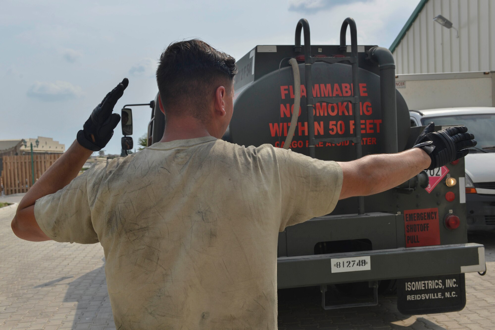 U.S. Air Force Airman 1st Class Trenton Beard, 39th Logistics Readiness Squadron (LRS) fuels specialist, guides Airman 1st Class Eduardo Reyes, 39th LRS fuels specialist, as he backs a fuel truck July 19, 2016, at Incirlik Air Base, Turkey. Beard and Reyes went around base refueling generators, enabling power to base facilities. (U.S. Air Force photo by Senior Airman John Nieves Camacho)