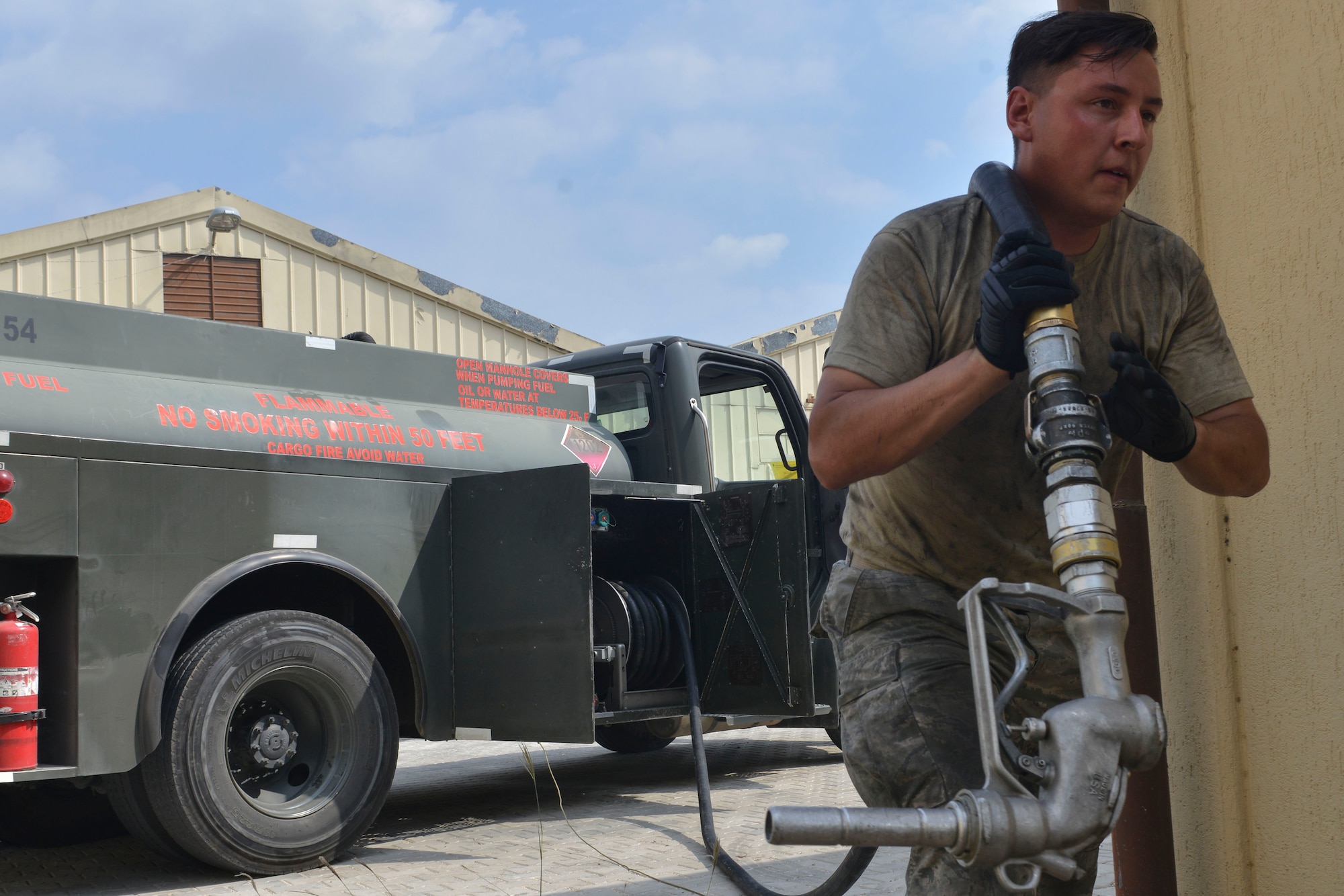 U.S. Air Force Airman 1st Class Trenton Beard, 39th Logistics Readiness Squadron fuels specialist, carries a hose to a generator July 19, 2016, at Incirlik Air Base, Turkey. Base personnel worked to keep electrical power supplied to the installation, ensuring mission readiness. (U.S. Air Force photo by Senior Airman John Nieves Camacho)