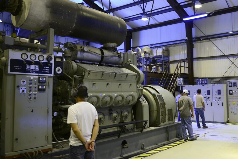 Contractors from the 39th Civil Engineer Squadron monitor a power plant generator July 20, 2016, at Incirlik Air Base, Turkey. Internal power was used due to an extended loss of commercial power to sustain missions here at Incirlik. (U.S. Air Force photo by Tech. Sgt. Caleb Pierce)