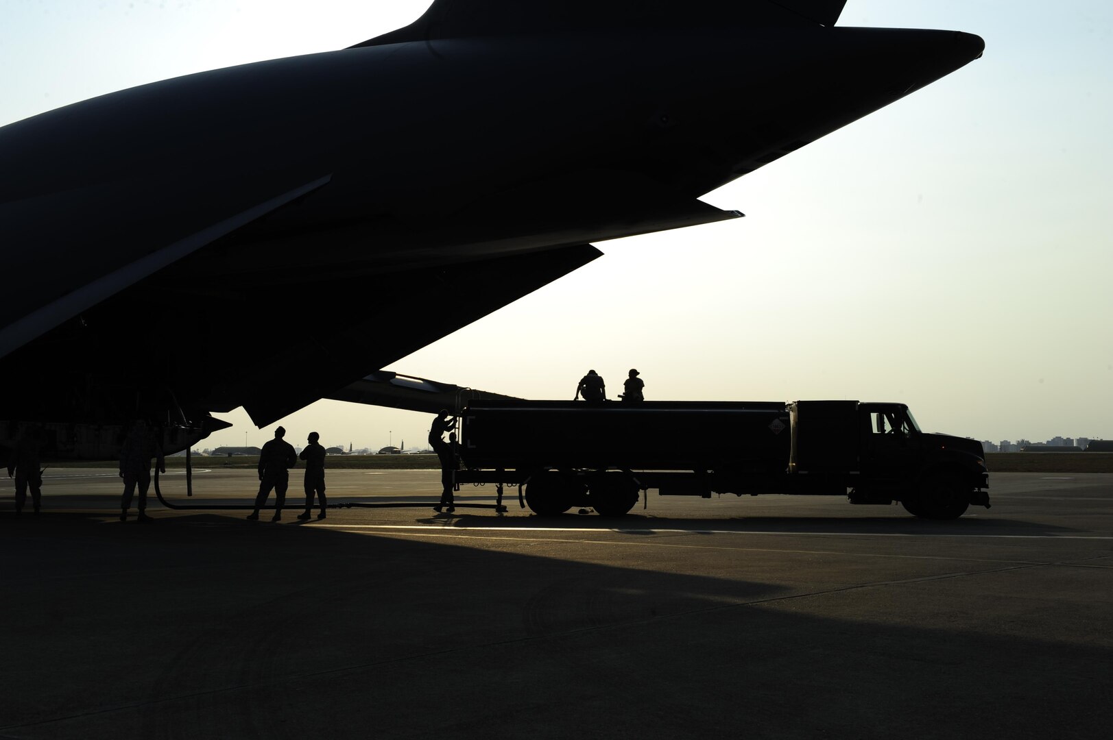 Airmen assigned to the 39th Logistics Readiness Squadron, unload fuel from a U.S. Air Force C-5M Super Galaxy July 22, 2016, at Incirlik Air Base, Turkey. Due to an extended loss of commercial power to the base, supplies, including food, water and fuel were delivered to sustain missions here at Incirlik. (U.S. Air Force photo by Airman 1st Class Devin M. Rumbaugh)
