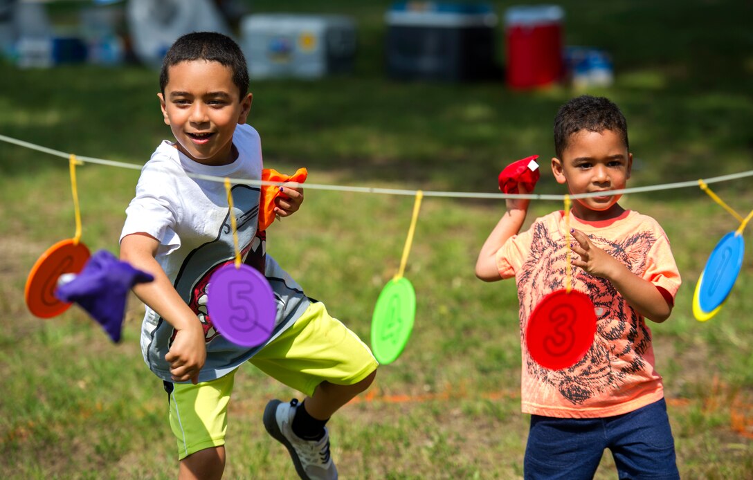 Maxwell and Nicholas, children of a military member, toss bean bags during the Joint Base Andrews Library field day held on JBA, Md., July 22, 2016. The event was part of the Department of Defense-Morale, Welfare and Recreation 2016 Summer Reading Program “Read for the Win,” a concept encouraging children to read during the summer months. (U.S. Air Force photo by Airman Gabrielle Spalding)