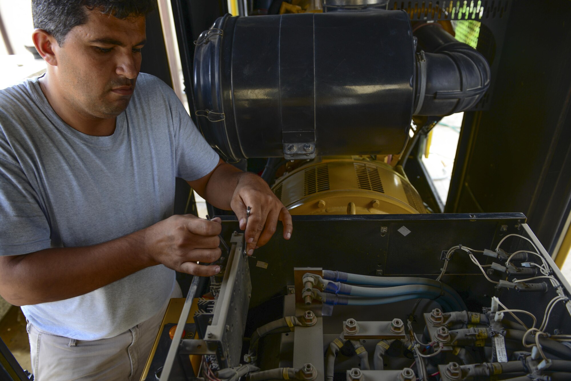 A 39th Civil Engineer Squadron contractor performs maintenance on a generator July 21, 2016, at Incirlik Air Base, Turkey. Maintenance was performed on multiple generators across the base that were used during a commercial power loss. (U.S. Air Force photo by Tech. Sgt. Caleb Pierce)