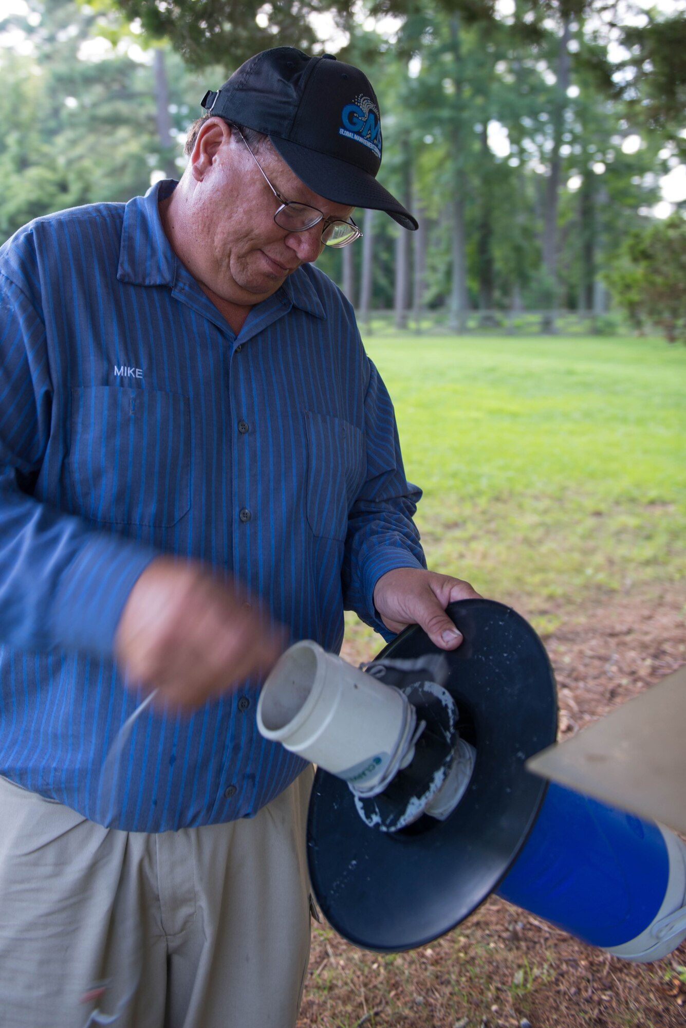 Michael Parise, base operating services pest control contractor, sets up a carbon dioxide and light trap at Magnolia Park at Fort Eustis, Va., July 13, 2016. Ft. Eustis Civil Engineer Division has been setting traps, collecting data and monitoring the populations concerning mosquitoes and ticks. (U.S. Air Force photo by Staff Sgt. J.D. Strong II)