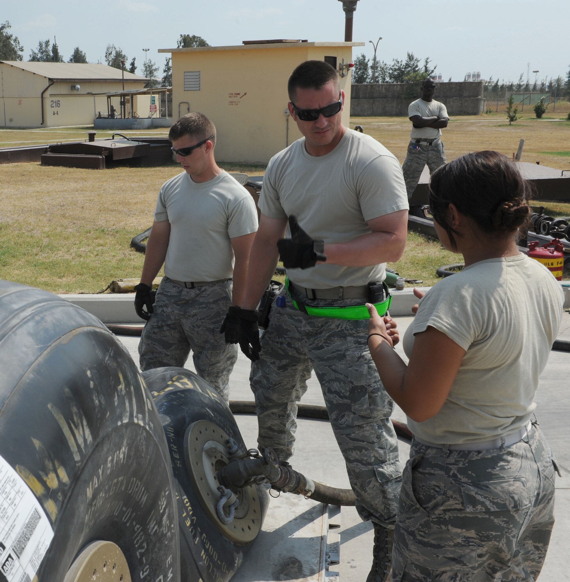 U.S. Air Force Staff Sgt. Christian Crider, (left), Tech. Sgt. Tony Otis, Staff Sgt. Brandon Jenkins and Senior Airman Samantha Perez, 39th Logistics Readiness Squadron petroleum oils and lubricants flight Airmen, unload fuel from bladders into bulk storage July 22, 2016, at Incirlik Air Base, Turkey. Due to an extended loss of commercial power to the base, supplies, including food, water and fuel were delivered to sustain missions here at Incirlik. (U.S. Air Force photo by Staff Sgt. Jack Sanders)