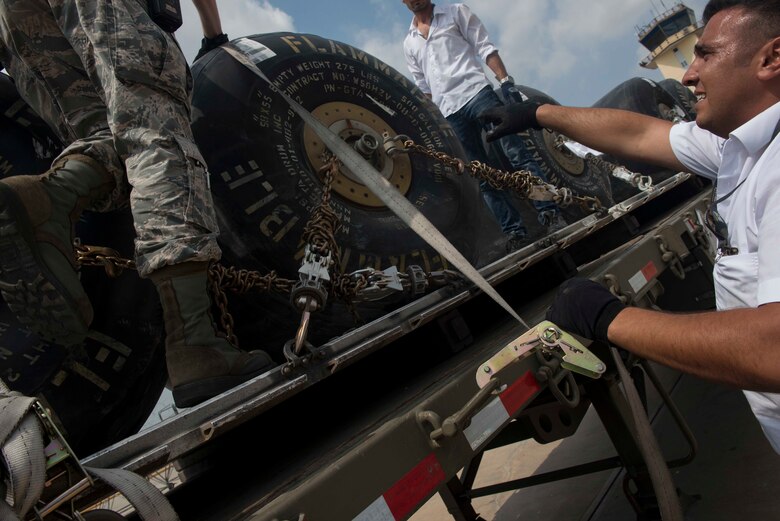 Members of the 728th Air Mobility Squadron work together to secure fuel bladders for transport July 22, 2016, at Incirlik Air Base Turkey. The fuel bladders were transported and dispensed into a bulk fuel storage. (U.S. Air Force photo by Senior Airman John Nieves Camacho)