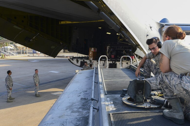 Airmen from the 39th Logistics Readiness Squadron fuels flight, receive fuel from a bladder off a U.S. Air Force C-5M Super Galaxy July 22, 2016, at Incirlik Air Base, Turkey. After an extended loss of commercial power to the base, supplies, including food, water and fuel, were delivered to sustain missions here at Incirlik. (U.S. Air Force photo by Tech. Sgt. Caleb Pierce)