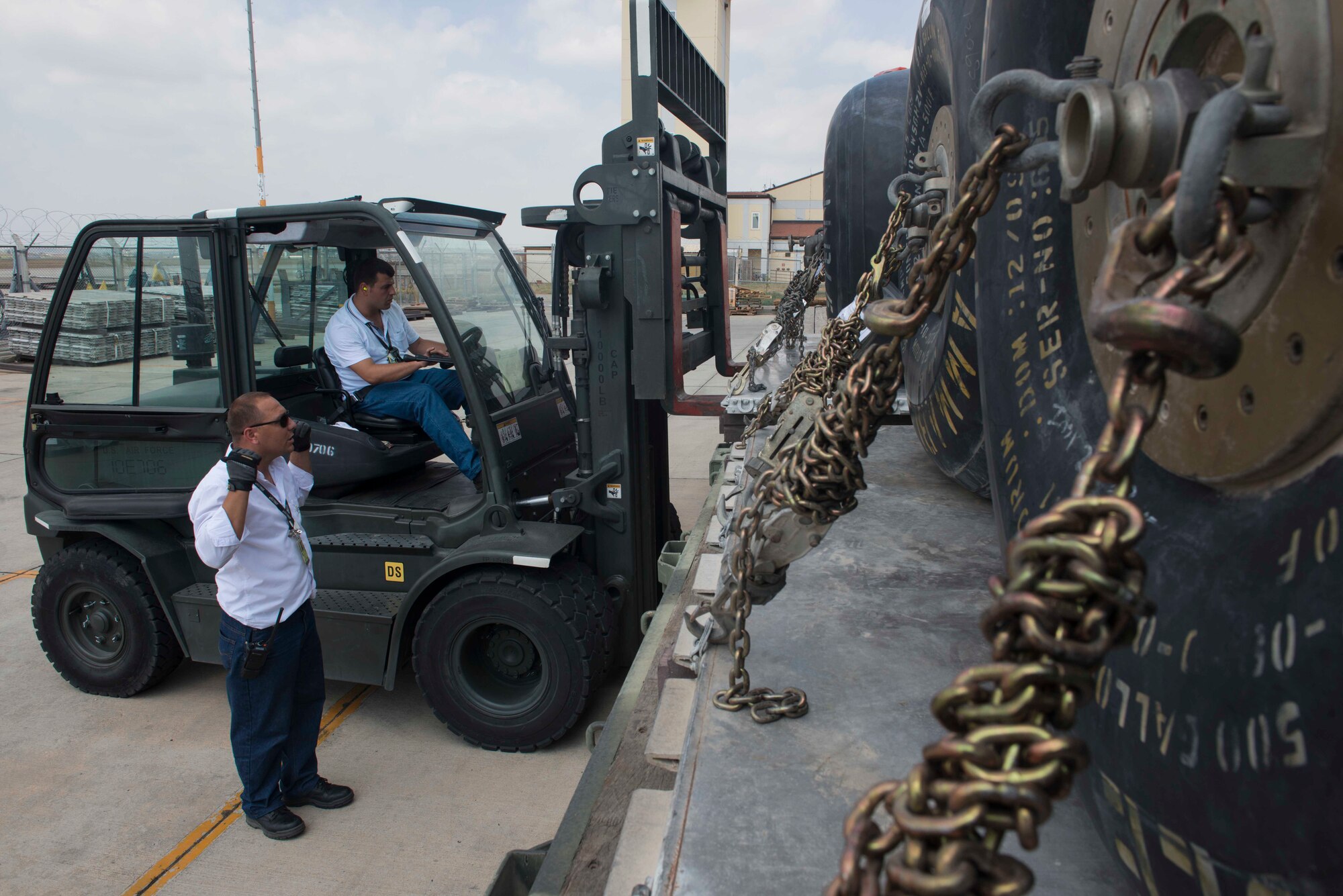 Contractors from the 728th Air Mobility Squadron (AMS) load fuel bladders on a truck for transport July 22, 2016, at Incirlik Air Base Turkey. Members from the 728th AMS unloaded the fuel bladders from aircraft and loaded them on trucks for transport. (U.S. Air Force photo by Senior Airman John Nieves Camacho)