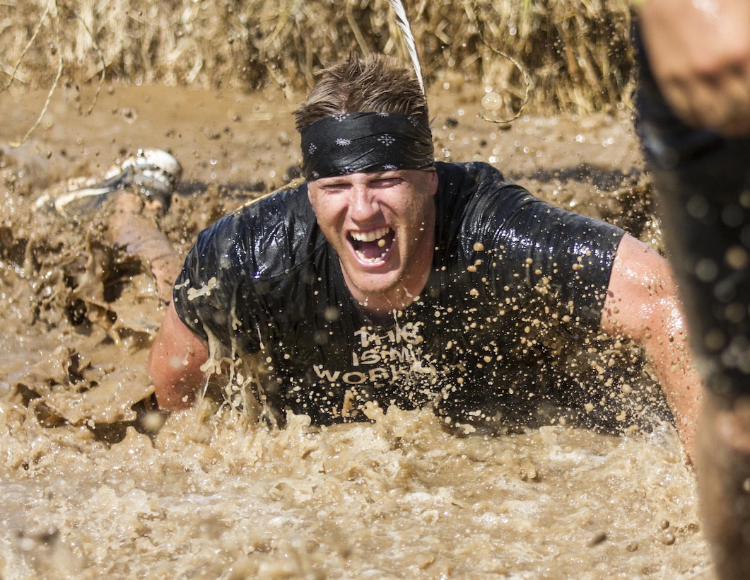 A participant in this year's Twin Cities Tough Mudder in Hugo, MN, takes a dive into muddy waters after getting a 10,000 volt shock from the Electroshock Therapy obstacle. Electroshock Therapy is the last obstacle participants must navigate. (U.S. Army photo by Staff Sgt. Cliff Coy)