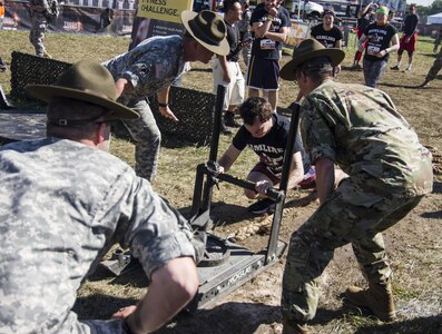 Army Reserve Drill Sergeants motivate a participant of the Army Reserve Fitness Challenge during this year's Twin Cities Tough Mudder in Hugo, MN. The Army Reserve has sponsored ten Tough Mudder events across the United States in order to bring more awareness about the Army Reserve to the community. (U.S. Army photo by Staff Sgt. Cliff Coy)