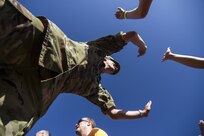 Staff Sgt. Phillip Hanneman with the St. Paul Recruiting Co. out of Roseville, MN, gives high fives to partipants in this year's Twin Cities Tough Mudder in Hugo, MN. The Army Reserve has sponsored ten Tough Mudder events across the United States in order to bring more awareness about the Army Reserve to the community. (U.S. Army photo by Staff Sgt. Cliff Coy)