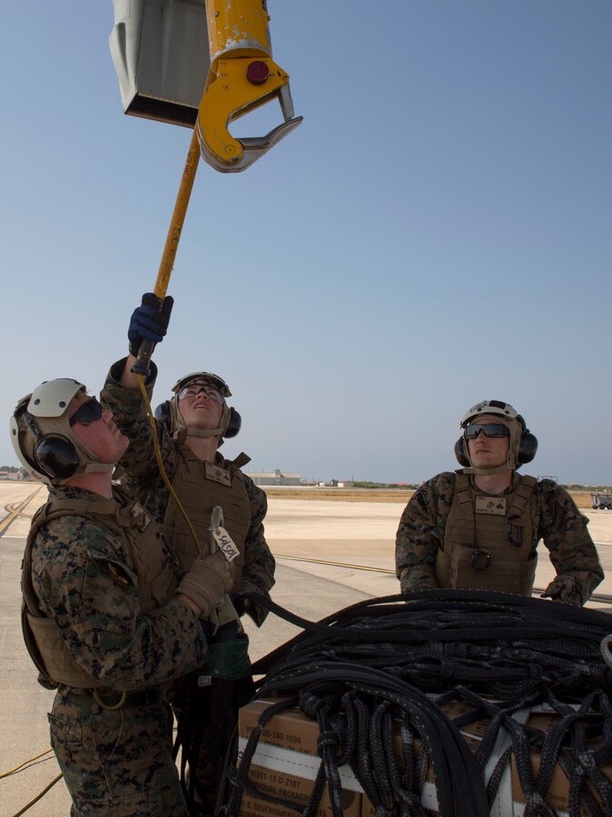 Landing support specialists with Combat Logistics Battalion 2, Special Purpose Marine Air-Ground Task Force-Crisis Response-Africa, attach a 1,098 pound pallet of Meals, Ready to Eat to an MV-22B Osprey during a helicopter support team exercise aboard Naval Station Rota, Spain, July 6, 2016. The HST training was conducted to increase proficiencies in logistics tasks and to enhance the ability to execute potential contingency missions. (U.S. Marine Corps photo by Staff Sgt. Tia Nagle/Released)