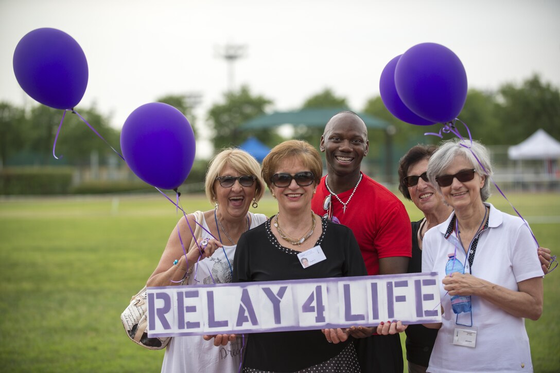 Participants pose for a photo during an American Cancer Society Relay for Life event, July 23, 2016, at Aviano Air Base, Italy. Since its creation in 1985, Relay for Life has raised nearly $5 billion worldwide. (U.S. Air Force photo by Airman 1st Class Cory W. Bush/Released)