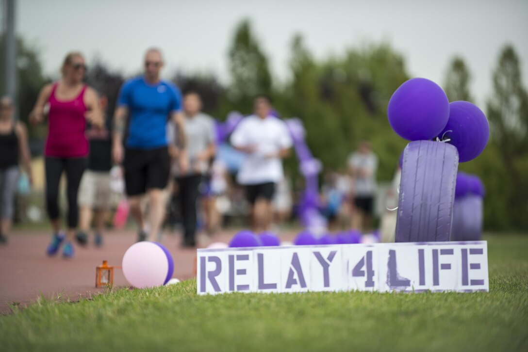 A Team Aviano member runs around the base track during an American Cancer Society Relay for Life event July 23, 2016, at Aviano Air Base, Italy. The relay lasted 24 hours and featured a military working dog demonstration, bean-bag-toss contest and live music. (U.S. Air Force photo by Airman 1st Class Cory W. Bush/Released)