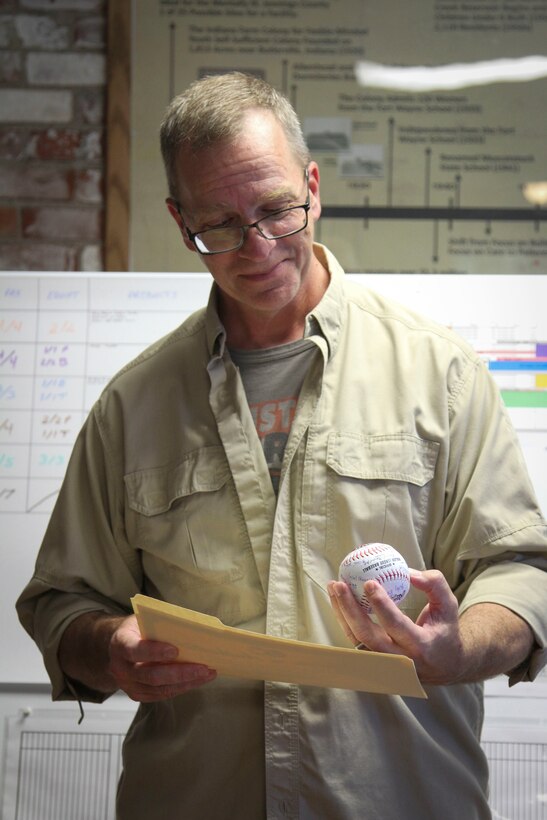 Butlerville, Ind. - Master Sgt. Brad Staggs, Atterbury-Muscatatuck public affairs and avid Astros fan, admires his certificate of appreciation and a baseball signed by the fifth rotation of Exercise News Day team members. Exercise News Day is a training exercise designed to sharpen the skills of photo and broadcast journalist during the Soldiers from the 205th Press Camp Headquarters and subordinate detachments annual training July 15-29, 2016.