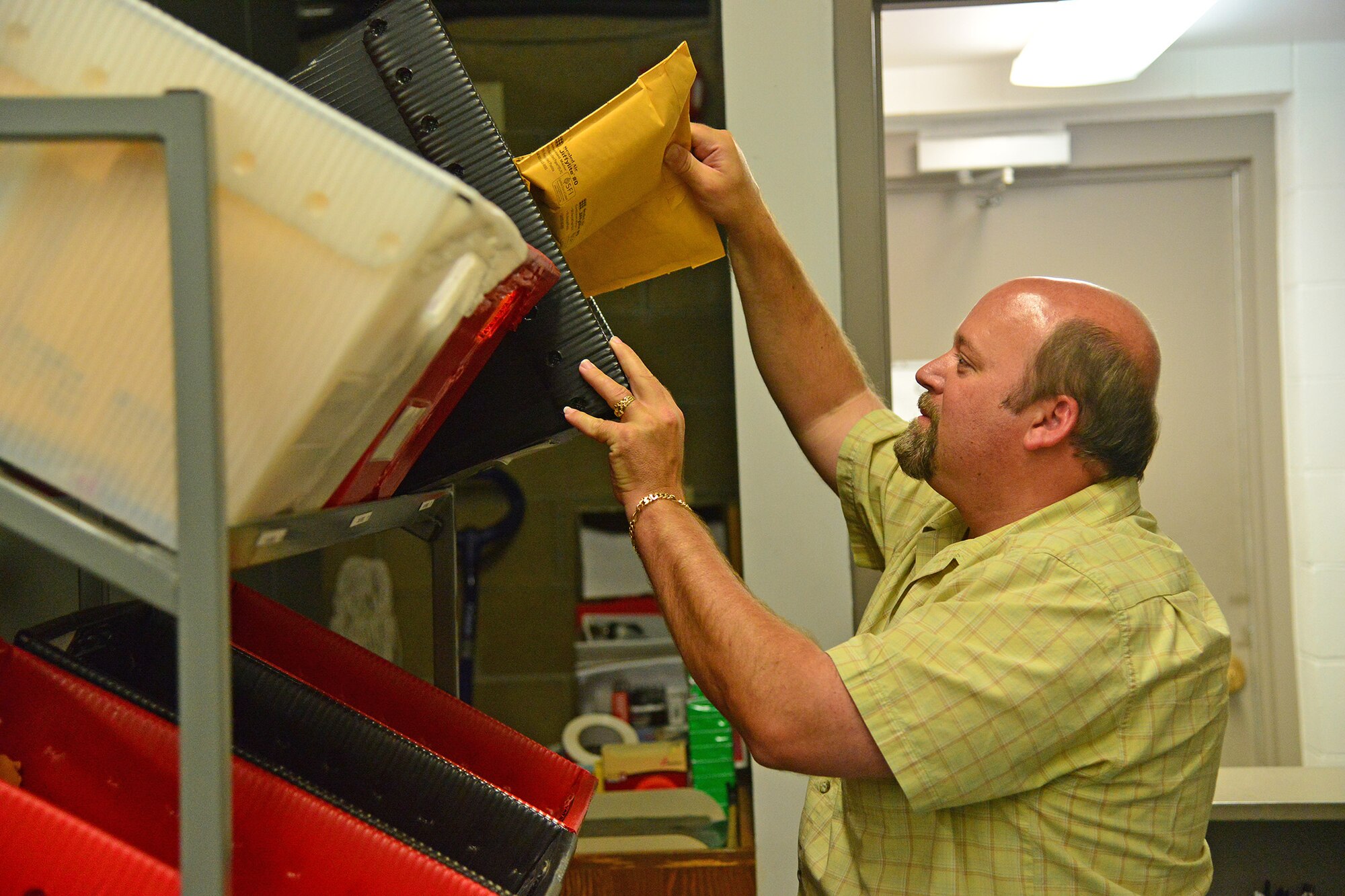 John Marsh, 341st Communications Squadron base Freedom of Information Act and Privacy Act manager, separates official mail into bins July 25, 2016, at Malmstrom Air Force Base, Mont. Marsh supervises the base records program, publications as well as the official mail center. (U.S. Air Force photo/Airman 1st Class Daniel Brosam)