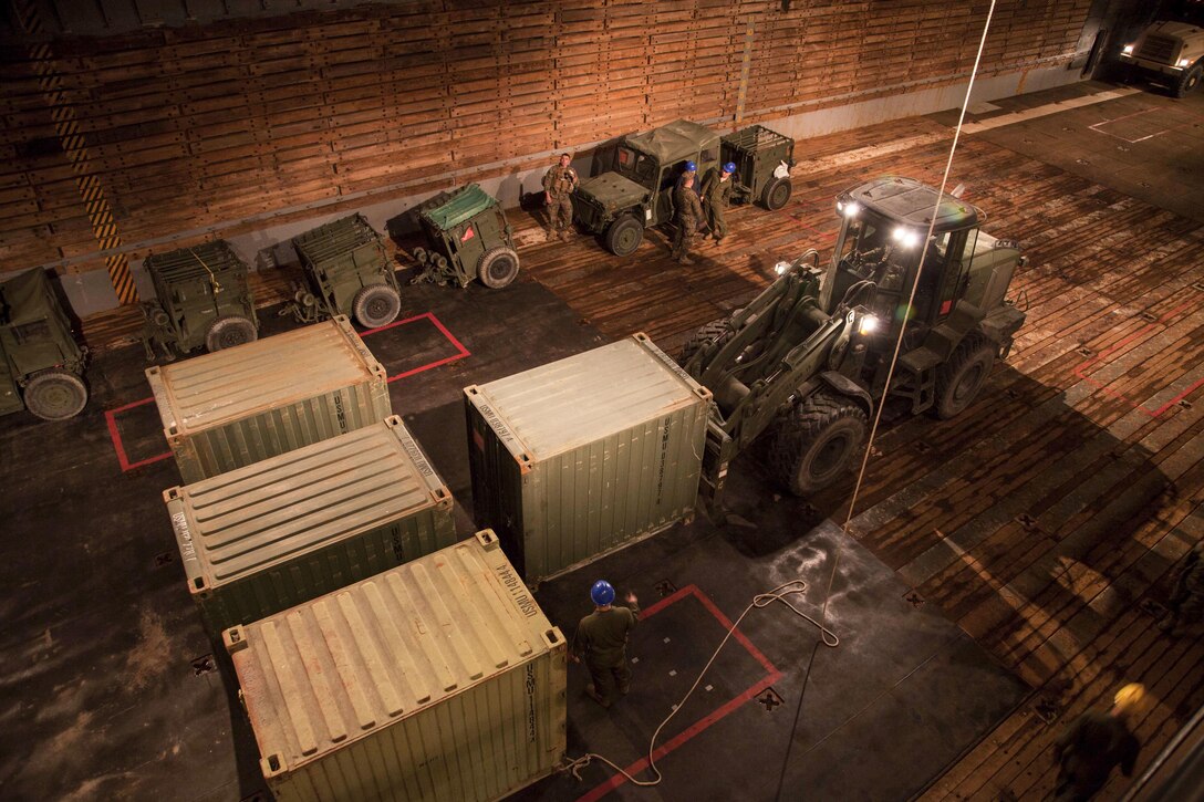 U.S. Marines with the 22nd Marine Expeditionary Unit (MEU) load and arrange containers into the USS Whidbey Island (LSD 41) well deck, March 18, 2016. The Marines and Sailors worked together in preparation for an upcoming deployment with 22 MEU.