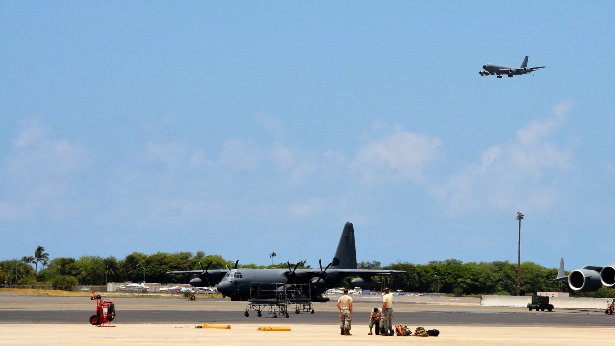 JOINT BASE PEARL HARBOR-HICKAM - U.S. Air Force maintenance crews with the 507th Aircraft Maintenance Squadron at Tinker Air Force Base, Okla., prepare to recover the KC-135R Stratotanker pictured landing overhead following an aerial refueling mission as part of Rim of the Pacific 2016. (U.S. Air Force photo\Tech. Sgt. Lauren Gleason)