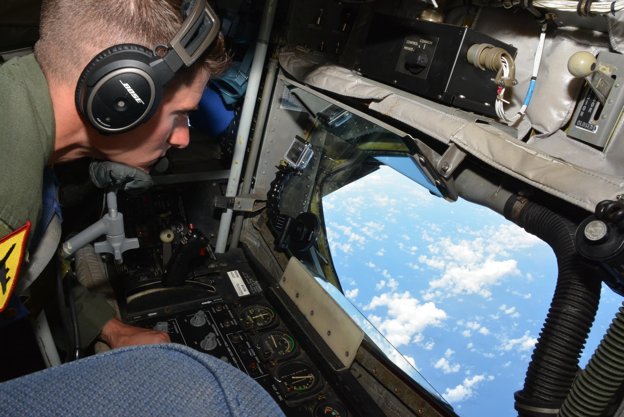 160720-F-EW270-112 JOINT BASE PEARL HARBOR-HICKAM (July 20, 2016) U.S. Air Force Staff Sgt. Tyler Sorrels, a KC-135R Stratotanker boom operator assigned to the 465th Air Refueling Squadron at Tinker Air Force Base, Okla., prepares the refueling boom to offload 49,700 lbs. of fuel to six U.S. Navy F-18 Hornets and two Canadian CF-18 Hornets over the Pacific Ocean as part of Rim of the Pacific 2016. (U.S. Air Force photo/Tech. Sgt. Lauren Gleason)