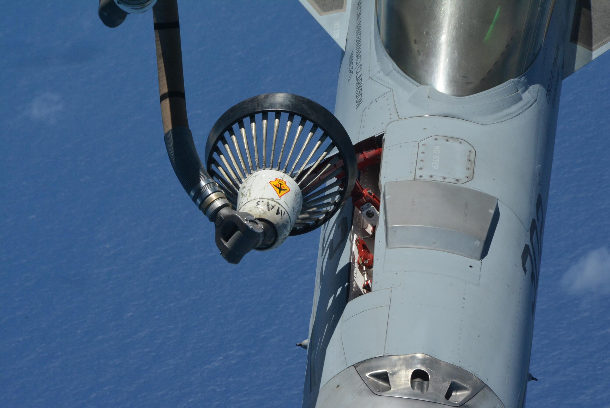 160720-F-EW270-181 JOINT BASE PEARL HARBOR-HICKAM (July 20, 2016) A refueling drogue from a KC-135R assigned to the 465th Air Refueling Squadron at Tinker Air Force Base, Okla., flies high over the Pacific Ocean while refueling a Navy F-18 Hornet as part of Rim of the Pacific 2016. (U.S. Air Force photo\Tech. Sgt. Lauren Gleason)