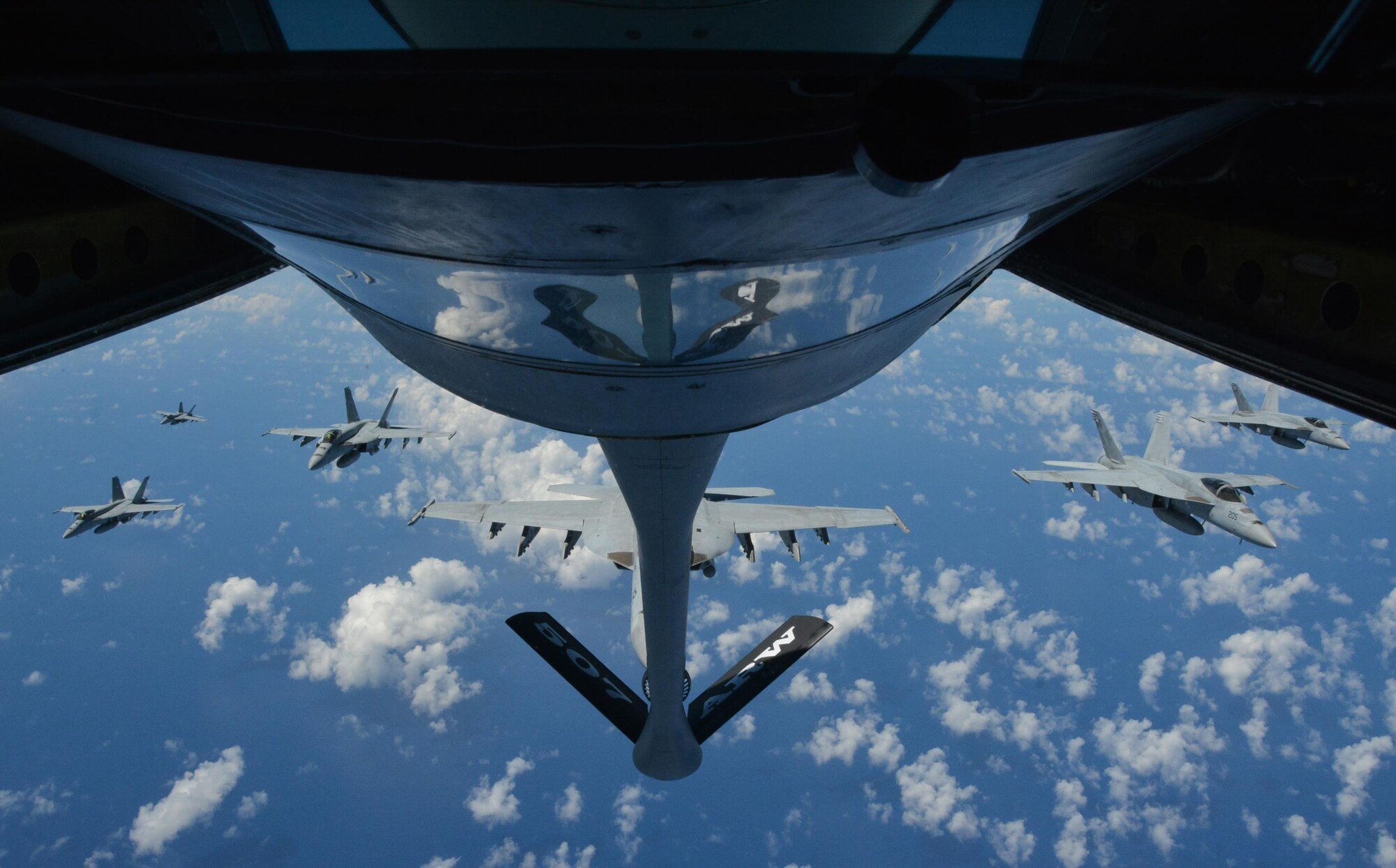 JOINT BASE PEARL HARBOR-HICKAM - Six U.S. Navy F-18 Hornets await refueling from a KC-135R Stratotanker belonging to the 465th Air Refueling Squadron at Tinker Air Force Base, Okla., during Rim of the Pacific 2016. (U.S. Air Force photo/Tech. Sgt. Lauren Gleason)