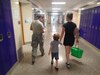 Tech Sgt. Lora “Lori” Olsen, a medical technician with the 174th Medical Group out of Syracuse, N.Y., leads a patient and her son from being seen by a medical provider to their next stop in optometry during Greater Chenango Cares, July 24, 2016.  Greater Chenango Cares is one of the Innovative Readiness Training events which provides real-world training in a joint civil-military environment while delivering world-class medical care to the people of Chenango County, N.Y., from July 15-24.
