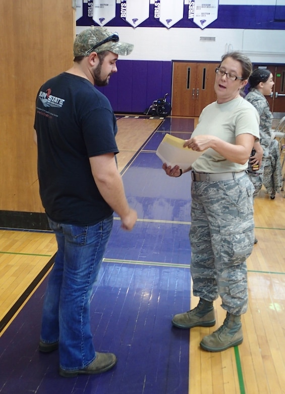 Tech Sgt. Lora “Lori” Olsen, a medical technician with the 174th Medical Group out of Syracuse, N.Y., checks a patient’s information before leading them to the medical section for care during Greater Chenango Cares, July 23, 2016.  Greater Chenango Cares is one of the Innovative Readiness Training events which provides real-world training in a joint civil-military environment while delivering world-class medical care to the people of Chenango County, N.Y., from July 15-24.